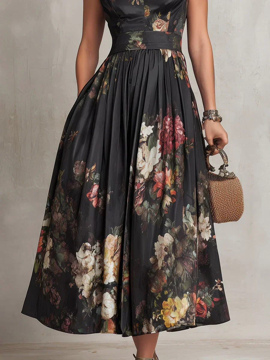 Vestido midi negro de seda plisado, con patrón floral y cuello alto